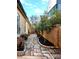 Backyard stone walkway with landscaping and an exterior view of home at 8812 Provence Village Ln, Charlotte, NC 28226