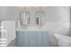 Bright bathroom features a double vanity with gold fixtures and a large soaking tub at 8812 Provence Village Ln, Charlotte, NC 28226