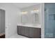 Bathroom features a double vanity with white countertops and a glass-enclosed shower at 8812 Provence Village Ln, Charlotte, NC 28226