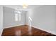 Empty bedroom featuring hardwood floors, overhead lighting, and a window at 8812 Provence Village Ln, Charlotte, NC 28226