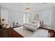 Serene bedroom with decorative lighting, arched windows, and hardwood floors, perfect for relaxation at 8812 Provence Village Ln, Charlotte, NC 28226