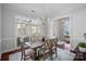 Spacious dining room with large windows and a stylish chandelier, ideal for Gathering gatherings at 8812 Provence Village Ln, Charlotte, NC 28226