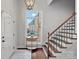 Bright entryway features hardwood floors, stairs, large windows and a decorative table at 8812 Provence Village Ln, Charlotte, NC 28226