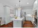 Bright kitchen featuring an island, stainless steel appliances, and lots of counter space for cooking at 8812 Provence Village Ln, Charlotte, NC 28226