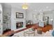 Inviting living room featuring a fireplace, an open layout to kitchen and gleaming hardwood floors at 8812 Provence Village Ln, Charlotte, NC 28226