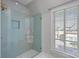 Bright shower with glass enclosure and light blue tile at 8812 Provence Village Ln, Charlotte, NC 28226