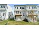 Townhome backyard featuring a deck and patio area surrounded by green grass at 9239 Delancey Nw Ln, Concord, NC 28027