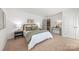 Comfortable bedroom with an ensuite bathroom, generous closet space, and neutral color scheme at 9239 Delancey Nw Ln, Concord, NC 28027