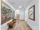 Inviting foyer with wood floors and a charming bench provides access to upper level at 9239 Delancey Nw Ln, Concord, NC 28027