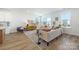 Inviting living room with modern furniture, large windows, and neutral décor with wood floors at 9239 Delancey Nw Ln, Concord, NC 28027