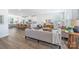 Bright, open-concept living room featuring a modern kitchen with stainless steel appliances and stylish furnishings at 9239 Delancey Nw Ln, Concord, NC 28027