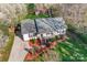 An aerial view of the cozy home showing its landscaped yard, driveway, and surrounding trees at 1025 Hunter Valley Rd, Shelby, NC 28150