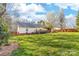 Expansive backyard featuring a spacious lawn, a deck, and a covered outdoor living area, ideal for relaxation at 1025 Hunter Valley Rd, Shelby, NC 28150