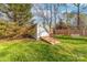 The backyard features a shed, and a porch swing on a lush lawn at 1025 Hunter Valley Rd, Shelby, NC 28150
