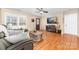 Cozy living room with hardwood floors, a ceiling fan, and a large window for plenty of natural light at 1025 Hunter Valley Rd, Shelby, NC 28150