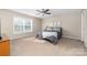 Comfortable bedroom with carpet, ceiling fan, and large windows that let in plenty of natural light at 1025 Hunter Valley Rd, Shelby, NC 28150