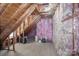 Unfinished attic space with exposed rafters and insulation at 10332 Hollybrook Dr, Charlotte, NC 28277