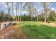 Expansive backyard with a lush lawn, mature trees, and plenty of space for recreation at 10332 Hollybrook Dr, Charlotte, NC 28277