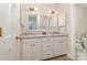 Bathroom with white dual sink vanity, large mirror, and stylish lighting fixtures at 10332 Hollybrook Dr, Charlotte, NC 28277