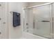 Bathroom with a shower and bath combo with a sliding glass door and a towel rack at 10332 Hollybrook Dr, Charlotte, NC 28277
