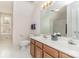 Bright bathroom with a double vanity, a large mirror, and a combined shower at 10332 Hollybrook Dr, Charlotte, NC 28277