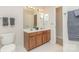 Bathroom with a double vanity, a large mirror, and white tiled floors at 10332 Hollybrook Dr, Charlotte, NC 28277