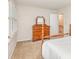 Cozy bedroom featuring neutral carpet, wood dresser, and a window with white shutters at 10332 Hollybrook Dr, Charlotte, NC 28277