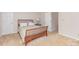 Cozy bedroom featuring a wooden bed frame, neutral walls, and carpet flooring at 10332 Hollybrook Dr, Charlotte, NC 28277