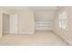 Neutral room with a built in bookcase and neutral carpet at 10332 Hollybrook Dr, Charlotte, NC 28277