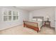 Cozy bedroom featuring neutral carpet, side table with lamp, and a shuttered window at 10332 Hollybrook Dr, Charlotte, NC 28277