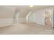 Empty bedroom with a dormer, neutral carpet and an entrance to the hallway at 10332 Hollybrook Dr, Charlotte, NC 28277