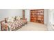 Neutral bedroom with a twin bed, wooden bookshelf, and carpet flooring at 10332 Hollybrook Dr, Charlotte, NC 28277