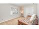 Well-lit bedroom with a twin bed, built-in shelves, plantation shutters, and neutral carpet at 10332 Hollybrook Dr, Charlotte, NC 28277