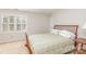 Bedroom with neutral carpet, shuttered window, and bed with a green bedspread at 10332 Hollybrook Dr, Charlotte, NC 28277