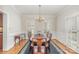 Formal dining room with chandelier, classic rug, and light filled windows at 10332 Hollybrook Dr, Charlotte, NC 28277