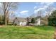 The backyard features a detached garage, brick patio, and a well maintained yard at 10332 Hollybrook Dr, Charlotte, NC 28277
