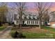 Charming traditional home featuring black shutters, dormer windows, well-maintained lawn, and tasteful landscaping at 10332 Hollybrook Dr, Charlotte, NC 28277