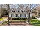 Beautifully landscaped home with symmetrical dormer windows, black shutters, and lush green lawn at 10332 Hollybrook Dr, Charlotte, NC 28277