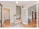 Bright foyer featuring hardwood floors, staircase, classic trim, and French doors with glass panes at 10332 Hollybrook Dr, Charlotte, NC 28277
