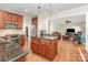 Open kitchen with wood cabinets, stainless appliances, and granite countertops at 10332 Hollybrook Dr, Charlotte, NC 28277