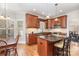 Kitchen with center island, wood cabinets and stainless steel appliances at 10332 Hollybrook Dr, Charlotte, NC 28277