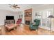 Comfortable living room with a fireplace, hardwood floors, stylish seating, and abundant natural light at 10332 Hollybrook Dr, Charlotte, NC 28277