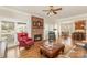 Cozy living room with a brick fireplace, hardwood floors, comfortable seating, and ample natural light at 10332 Hollybrook Dr, Charlotte, NC 28277