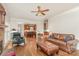 Spacious living room featuring hardwood floors, comfortable seating, and seamless flow to the kitchen at 10332 Hollybrook Dr, Charlotte, NC 28277