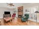 Inviting living room featuring hardwood floors, fireplace, seating, and lots of natural light at 10332 Hollybrook Dr, Charlotte, NC 28277