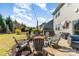 Backyard patio area with fire pit, seating, string lights, hot tub and view of the back of the home at 1037 Delridge St, Waxhaw, NC 28173