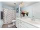 Bathroom featuring double sink vanity, butterfly shower curtain, and tile floor at 1037 Delridge St, Waxhaw, NC 28173