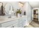 Bathroom featuring double sinks, vanity with white cabinets, and decorative mirrors at 1037 Delridge St, Waxhaw, NC 28173