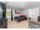 This bedroom has a neutral color palette, a picture window, a closet and a modern desk with a place to sit at 1037 Delridge St, Waxhaw, NC 28173