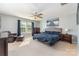 Spacious bedroom with ceiling fan, sitting area, neutral carpet, and a king-size bed at 1037 Delridge St, Waxhaw, NC 28173